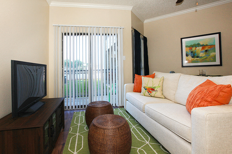 A living room with a white couch and a television.